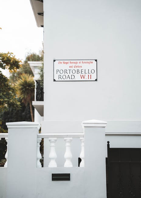 A white rectangular sign with black lettering that reads 'NO DUMPING OF RUBBISH' is mounted on a red brick wall. The bricks are arranged in a traditional horizontal pattern, with some darker bricks sc